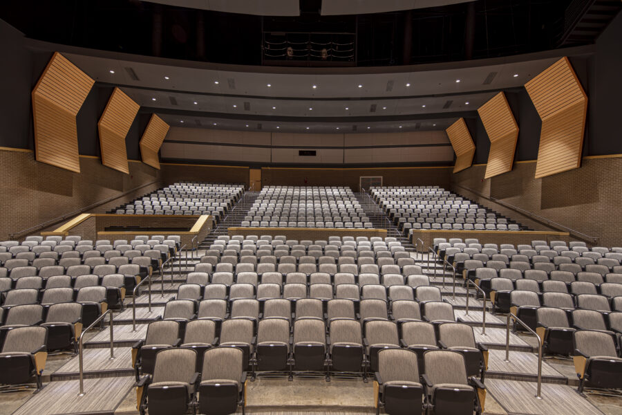 Audience seating and acoustic wall panels inside the Mills Performing Arts Center auditorium.