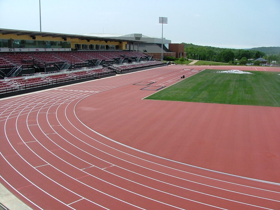 University of Arkansas John McDonnell Field in Fayetteville, AR, featuring an outdoor competition track and covered grandstand.
