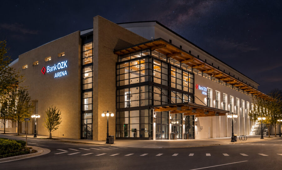 Night exterior of the Hot Springs Convention Center in Arkansas featuring its glass entrance and wood canopy, designed by WDD Architects.