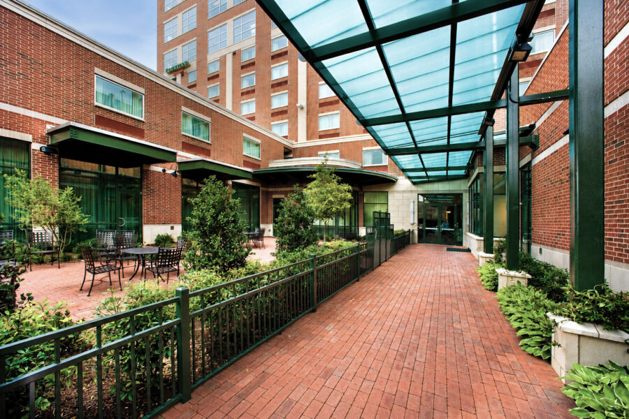 First Security Bank headquarters in downtown Little Rock, Arkansas, featuring a landscaped courtyard with brick paving and a glass canopy, designed by WDD Architects.