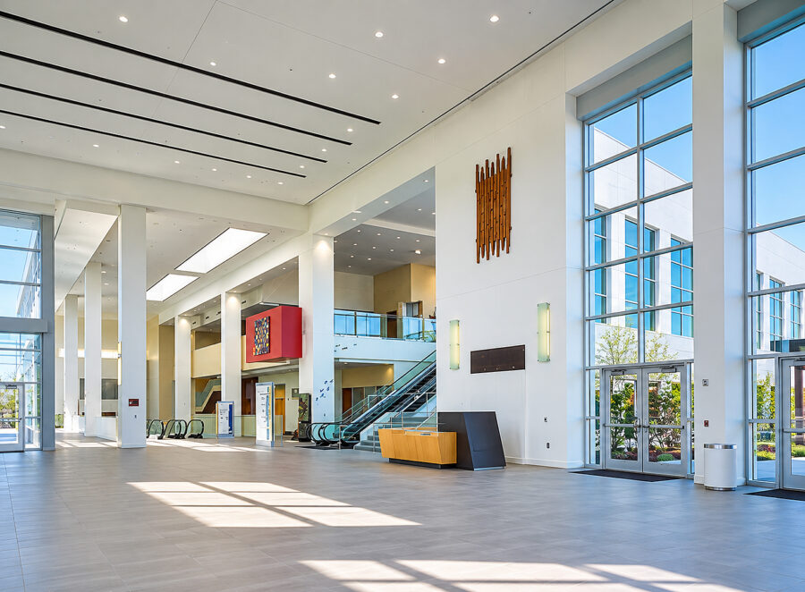 Statehouse Convention Center lobby in Little Rock, AR, featuring a spacious atrium, floor-to-ceiling windows, escalators and abundant natural light, designed by WDD Architects.