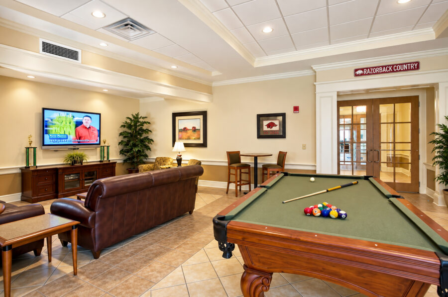Recreation room at the University of Arkansas Sigma Nu Fraternity House in Fayetteville, AR, featuring a pool table and lounge seating designed by WDD Architects.