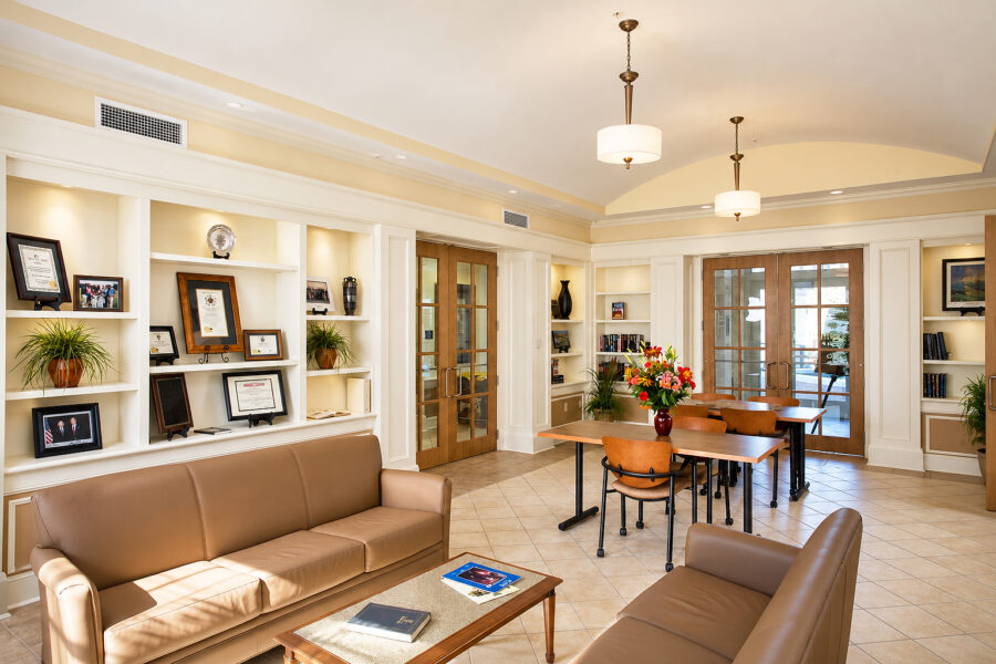 Student lounge at the University of Arkansas Sigma Nu Fraternity House in Fayetteville featuring built-in shelving and gathering space.