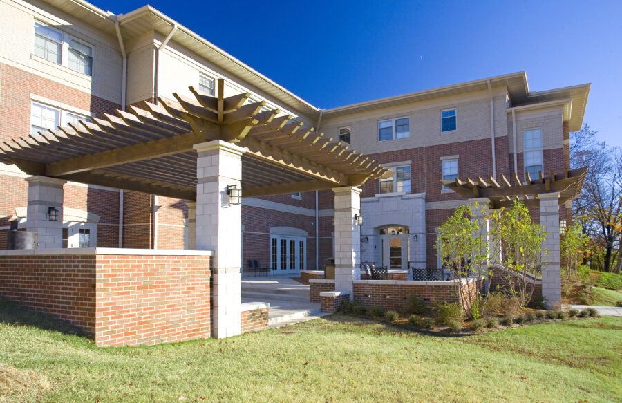 Outdoor courtyard and pergola at the University of Arkansas Sigma Nu Fraternity House in Fayetteville, designed by WDD Architects