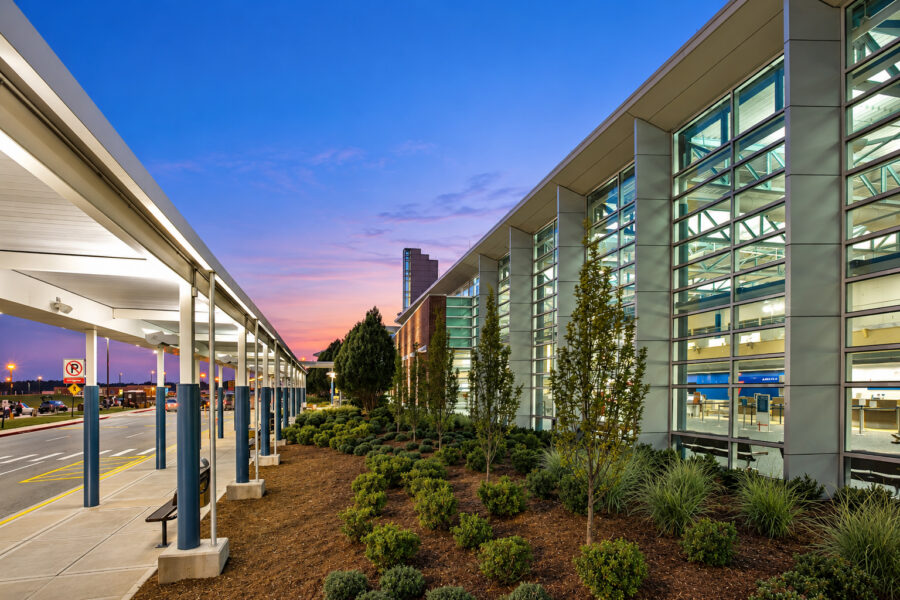 Exterior of Northwest Arkansas Regional Airport (XNA) featuring the glass terminal façade and covered passenger drop-off area