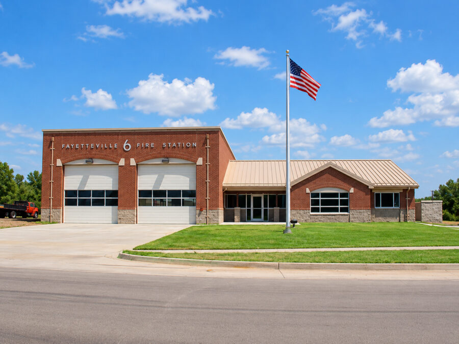 Fayetteville Fire Station #6 exterior in Fayetteville, AR, featuring brick construction, two garage bays, and a sloped metal roof designed by WDD Architects.