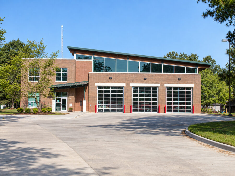 Fayetteville fire station in Fayetteville, AR, featuring three apparatus bays and a glass-fronted upper level, designed by WDD Architects.