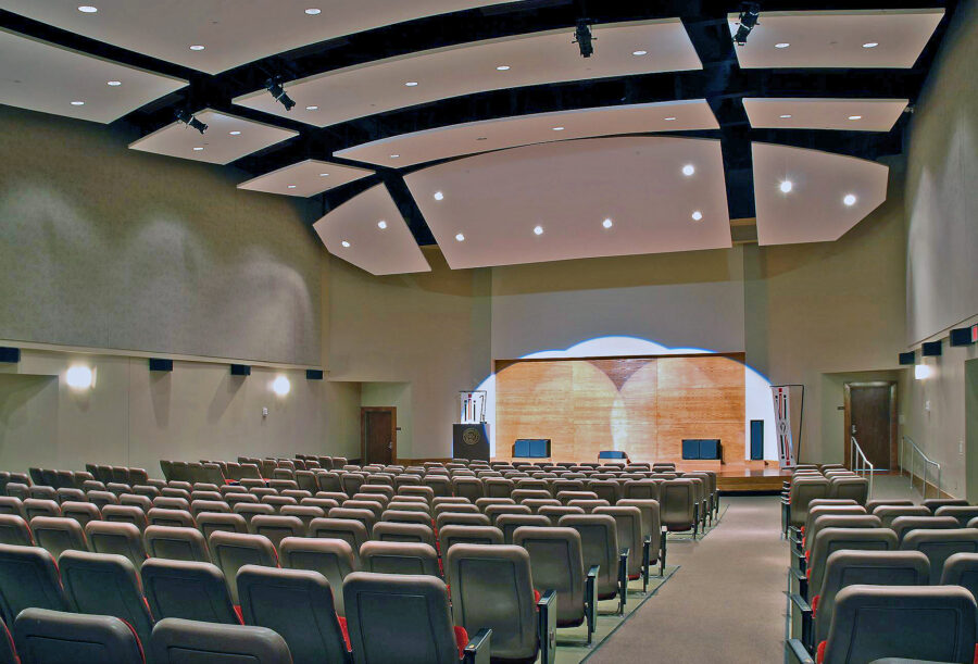 Arkansas State University Carl R. Reng Student Union auditorium in Jonesboro featuring tiered seating, a raised stage and sculptural acoustic ceiling panels.