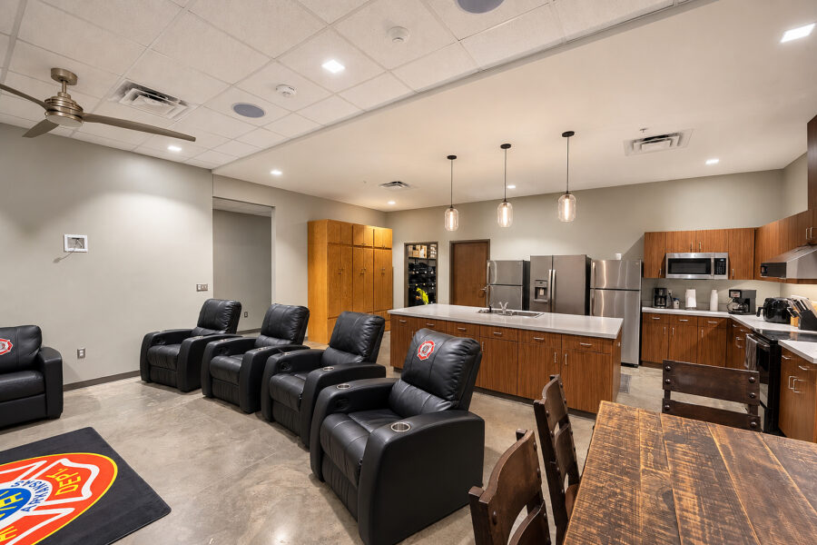Fire department breakroom and kitchen interior with leather recliners at Harrison Public Safety, designed by WDD Architects.