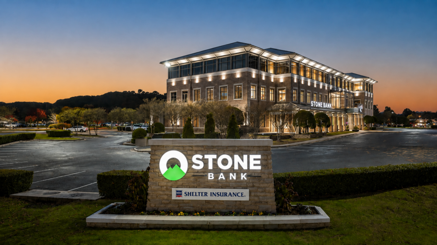 Exterior view of Stone Bank headquarters building and entrance sign at sunset in Little Rock, Arkansas, designed by WDD Architects.
