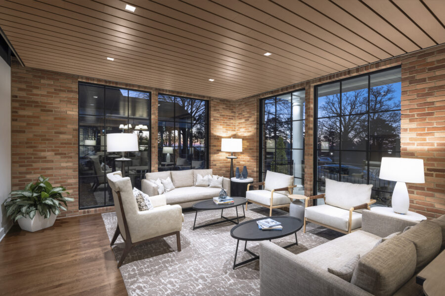 Lounge at the Country Club of Little Rock Commons Addition featuring comfortable seating, brick walls and large windows overlooking the grounds.