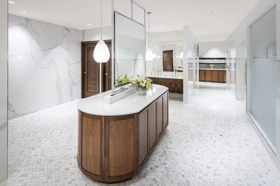Interior view of women's bathroom at the Country Club of Little Rock featuring marble walls and wood accents.